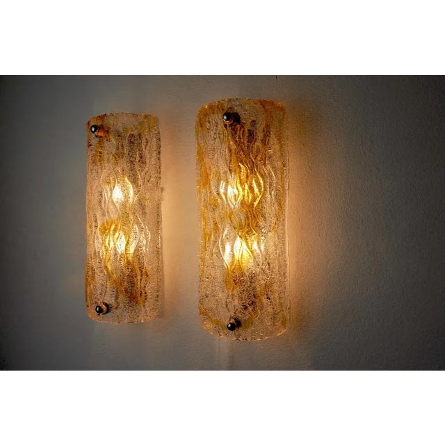 Very beautiful and rare pair of murano mazzega sconces designated and produced in italy in the 1960s. Composed of an...