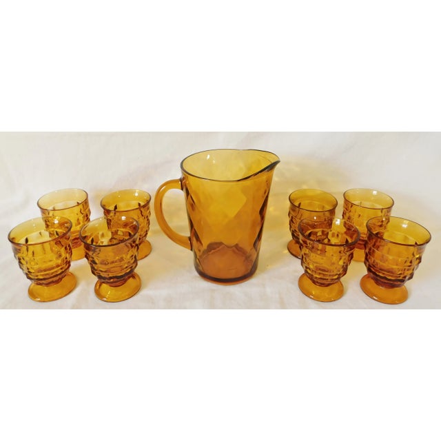 Gorgeous set of 8 Whitehall Colony Cube amber glass drinking glasses and a large amber glass diamond pitcher. Circa 1960s...