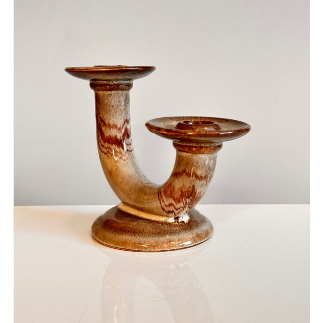 An elegant, sculptural design candleholder in glazed ceramic, manufactured in Germany during the 1920s.