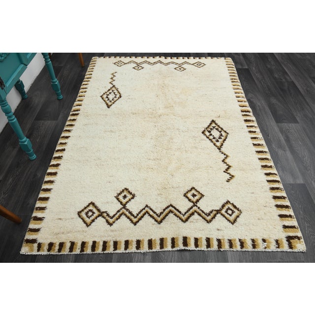 Vintage Turkish Hand-Knotted vintage rug is a semi-antique vintage area rug. The '70s Eastern region of Turkey's unique...