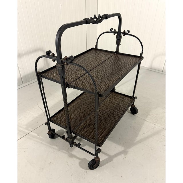 Brutalist handcrafted serving trolley. Wrought iron frame and iron table tops. The trolley can be very easily folded....