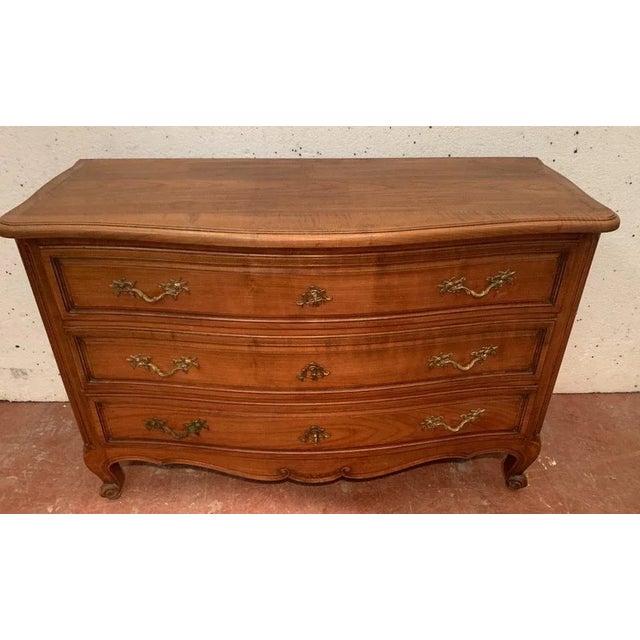 Provençal-style chest of drawers with curved front Molded walnut construction Three drawers on the front Rounded fluted...