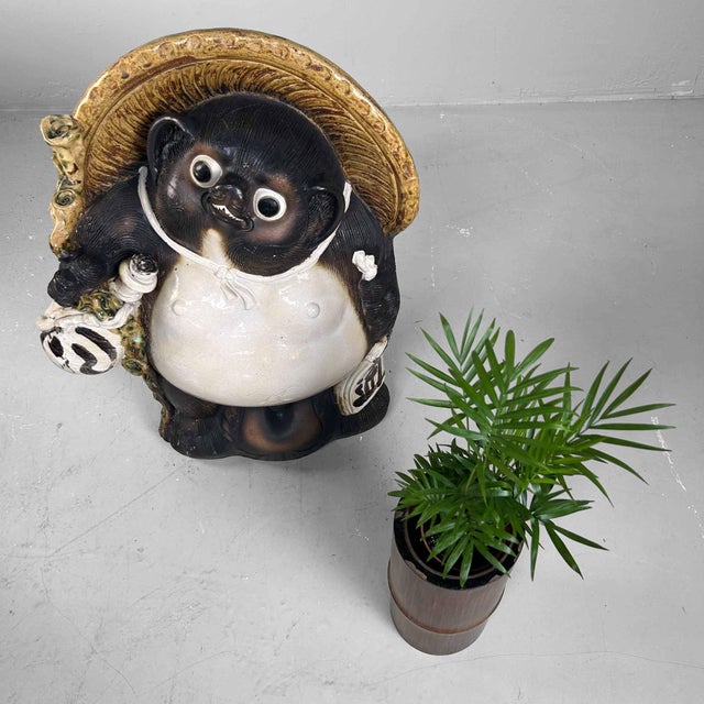 Large Tanuki Statue made of Shigaraki Pottery, 1980s, Shōwa Period, Japan. This Tanuki statue, crafted from Shigaraki...