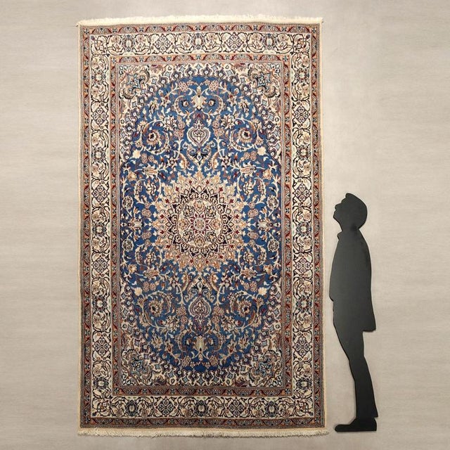 Main rug in cotton, wool, and silk. Hand-woven, large knot. This piece is attributed to the mentioned designer/maker. It...