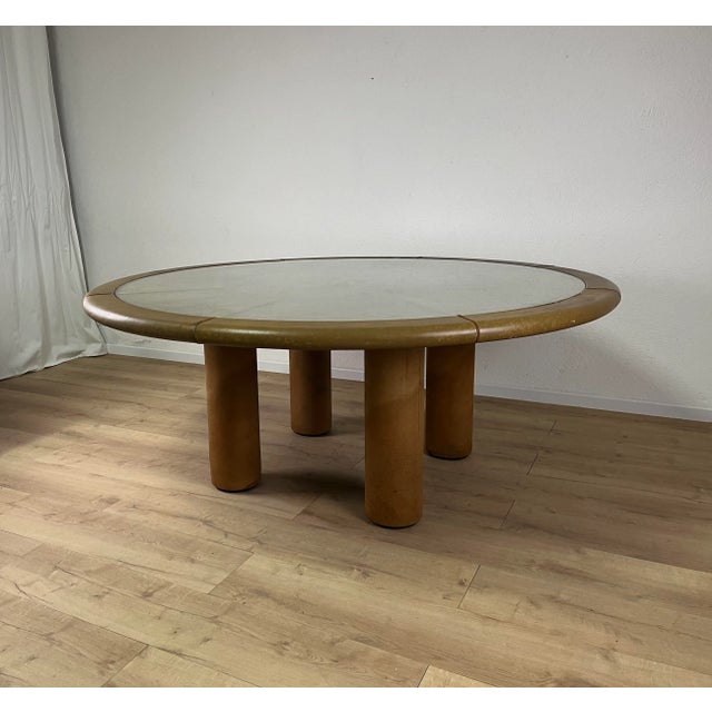 Large table with a wooden frame covered in leather and a glass top, Safari model designed by Redwall and produced in...