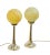 A slender table lamp with a gold-coloured base and a spherical shade made of marbled glass in a warm yellow shade. The...