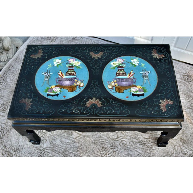 Vintage (1980's) Table has an Asian Style. Made of Wood. Carved Wood with a Black Lacquer Finish. and Two Cloisonné...
