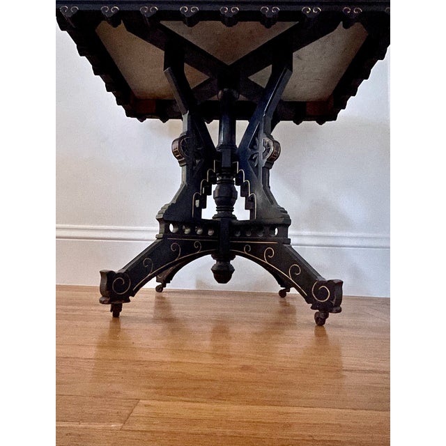 A beautiful Victorian Era table with a beveled Carrara marble top and a lovely black and gold painted wood base. Perfect...
