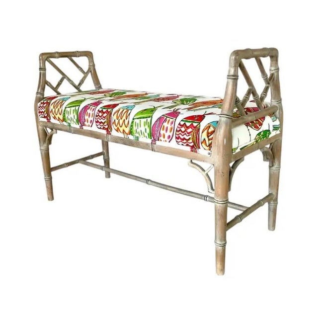 Vintage Bamboo Bench featuring a weathered frame with classic bamboo-form detailing and a vibrant upholstered cushion in a...