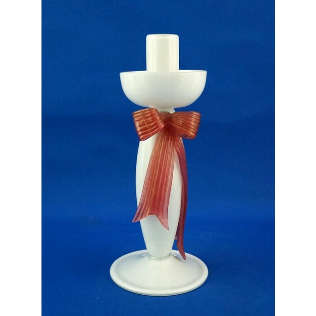 Delicate, large opaline glass candlestick with a pink glass bow appliqué, embellished with aventurine gold leaf, and a...