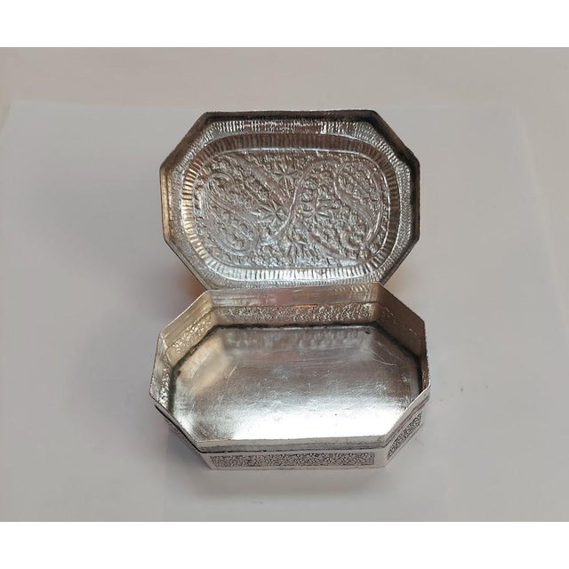 Found among a multigenerational silver collection, this decorative silver-tone box features clipped corners, flowing...