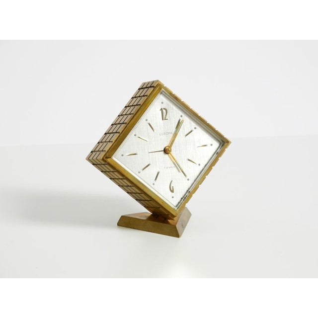 Rare, beautiful, small, original 1960s mechanical brass table clock by Europa. It features a built-in 7-day mechanical...