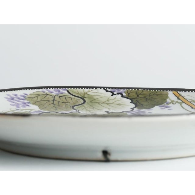 An exquisite hand-painted japanese porcelain charger showcasing the refined aesthetic of classic kutani ware. Set against...