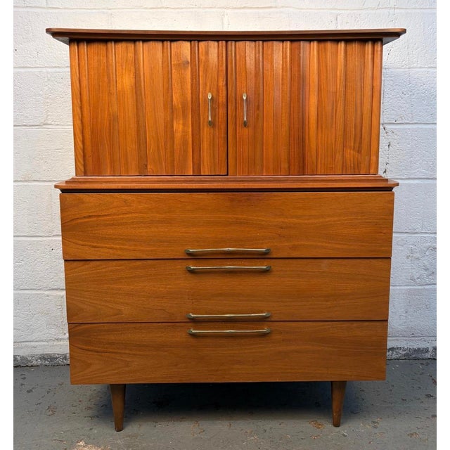 A classic mid-century modern highboy dresser in the United Style series, crafted by Young Manufacturing. Features clean...
