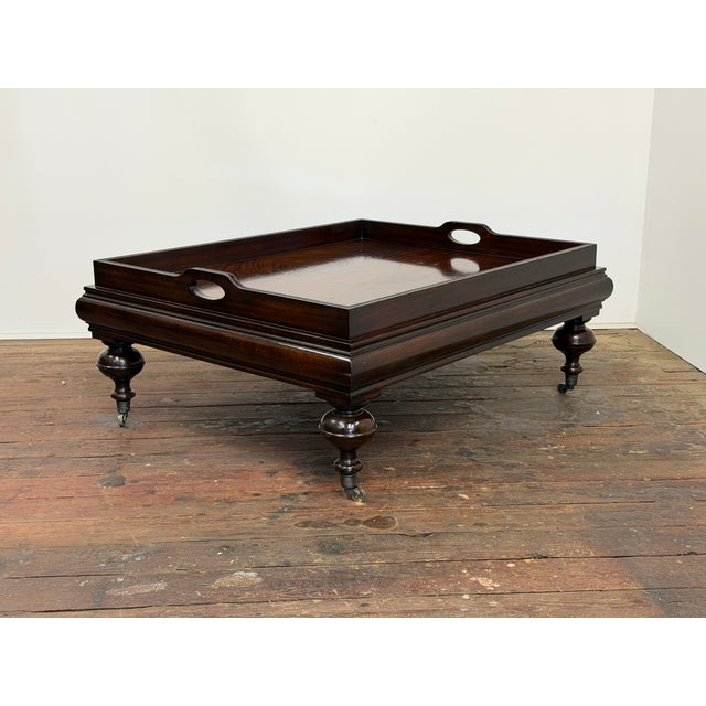 The New Bohemian mahogany cocktail table by Ralph Lauren. Featuring turned bulbous turned legs, a raised tray style top...