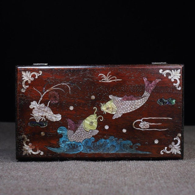 A beautifully crafted Chinese rectangular box, likely made of Zitan wood. The box features a hinged lid with brass...
