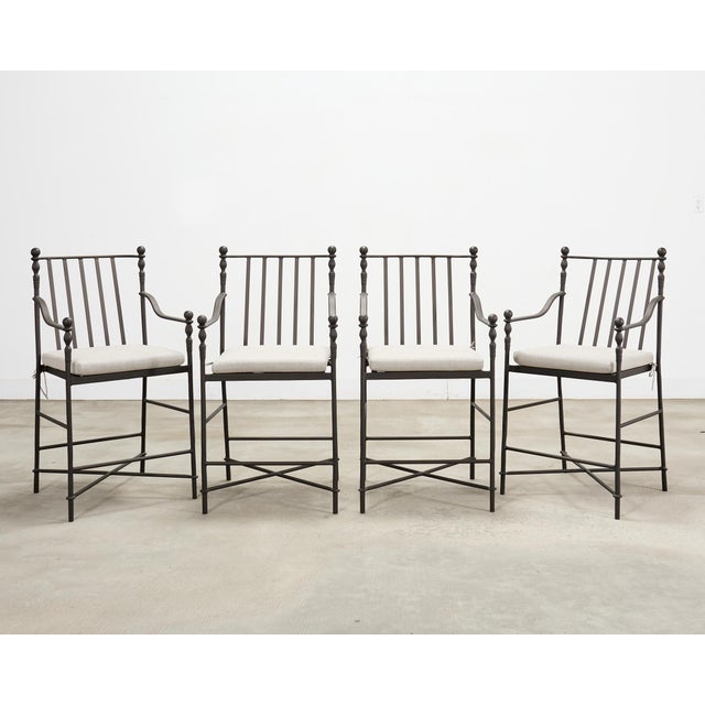 A handsome, iconic set of four bronzed "Montecito" garden counter barstools designed by Michael Taylor. The set features a...