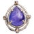 A lovely, large pear-shaped cabochon Tanzanite dome cocktail ring bordered with two rows of round, brilliant cut diamonds...