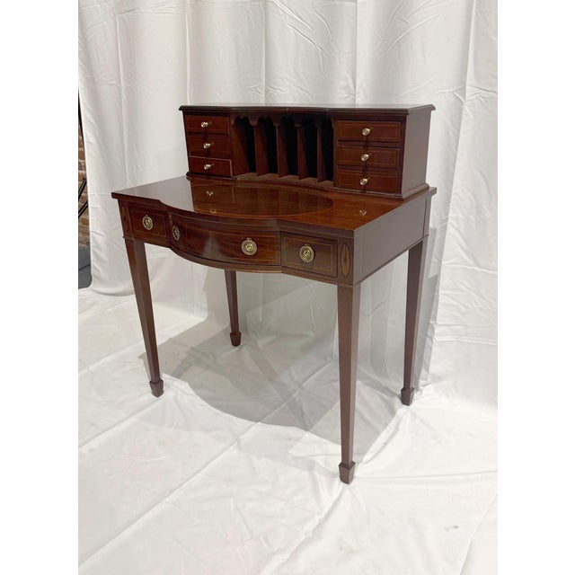 An exceptional Federal-style bow-front ladies' writing desk by Baker Furniture, crafted in the USA circa 1980s. This...
