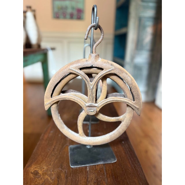 Add authentic industrial history to your collection with this striking set of three antique wood and cast iron pulleys,...