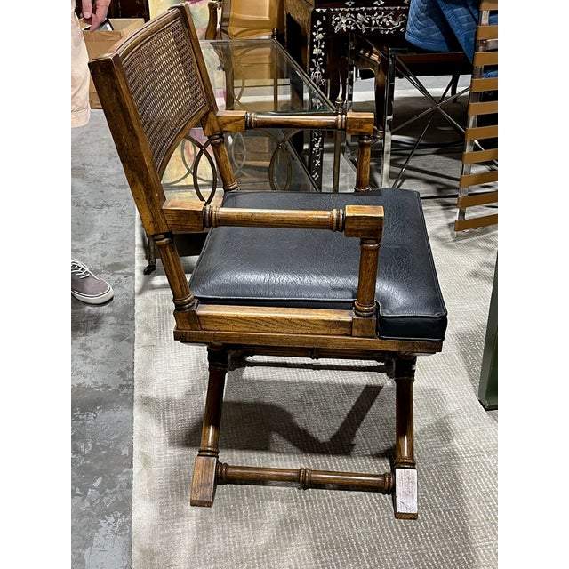 Campaign style arm chair you can pull up to a desk or writing table. Lightly distressed faux bamboo frame with brass...