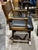 Campaign style arm chair you can pull up to a desk or writing table. Lightly distressed faux bamboo frame with brass...