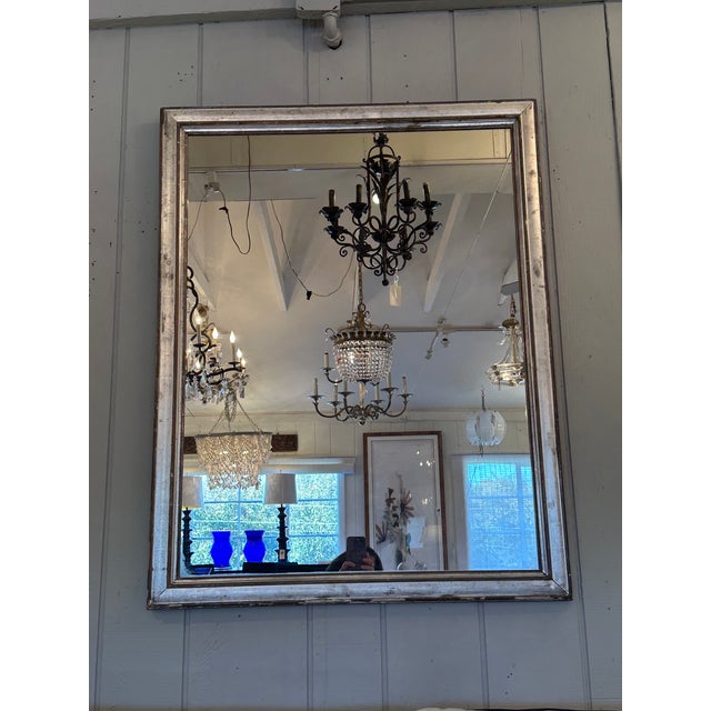 Large supremely elegant antique silver gilt wall mirror. The simplicity of lines and beautiful antique frame gives this...