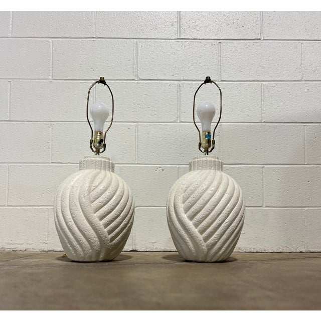 Beautiful matching pair of vintage white plaster table lamps with a swirling/scalloped pattern. They are wired for 3 way...