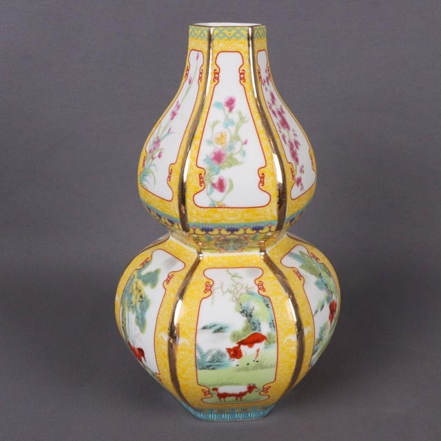 This exquisite double-gourd vase is a stunning example of Famille Jaune (yellow-ground) porcelain. The vibrant yellow body...