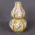 This exquisite double-gourd vase is a stunning example of Famille Jaune (yellow-ground) porcelain. The vibrant yellow body...