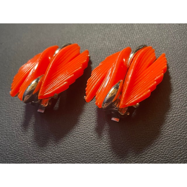 These vintage B.S.K. clip-on earrings feature a striking mid-century space-age design, crafted with cascading , bright...