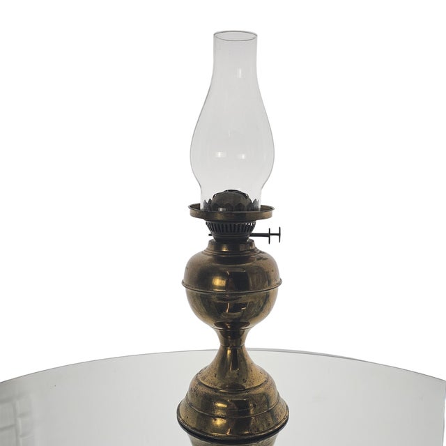 The brass stands with a quiet dignity, its surface carrying the soft patina of years well-lived. Above it, the chimney...