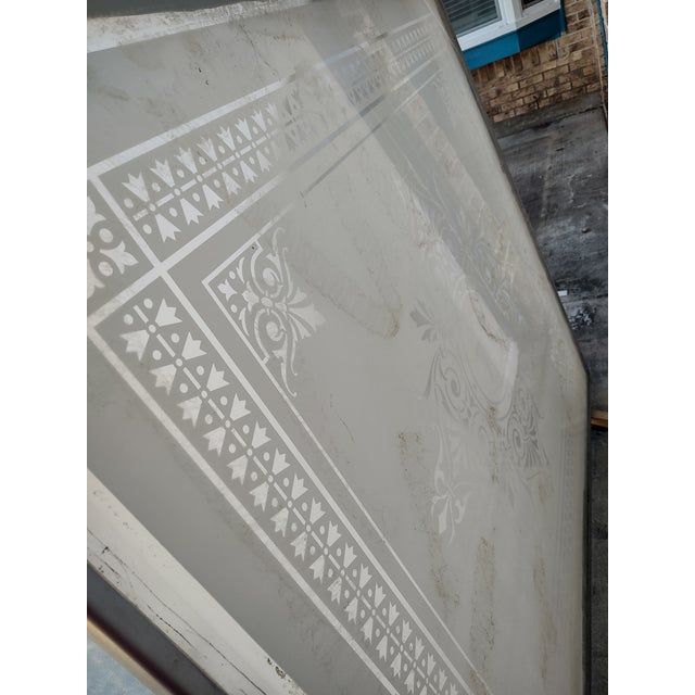 Monumental curved decorative skylight panel featuring a frosted translucent surface with an ornate classical stencil...