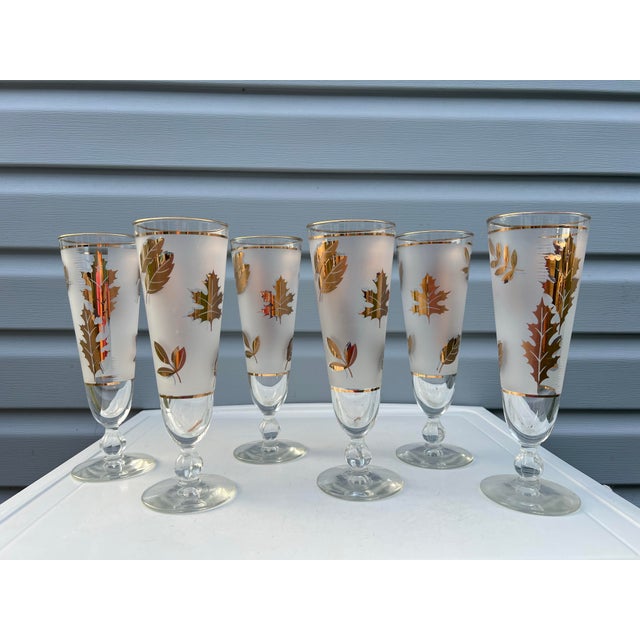 1950s Tall Vintage Libbey Golden Foliage Pilsner Glasses. These stemmed glasses have 22K gold leaf detailing fall foliage...