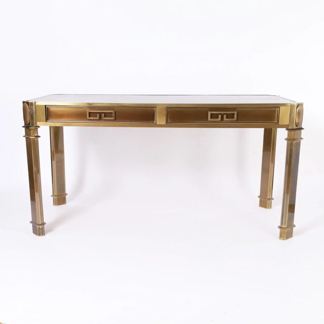 Impressive vintage writing desk crafted in bronze with a hip acid washed finish, in a stylized classic form having a black...