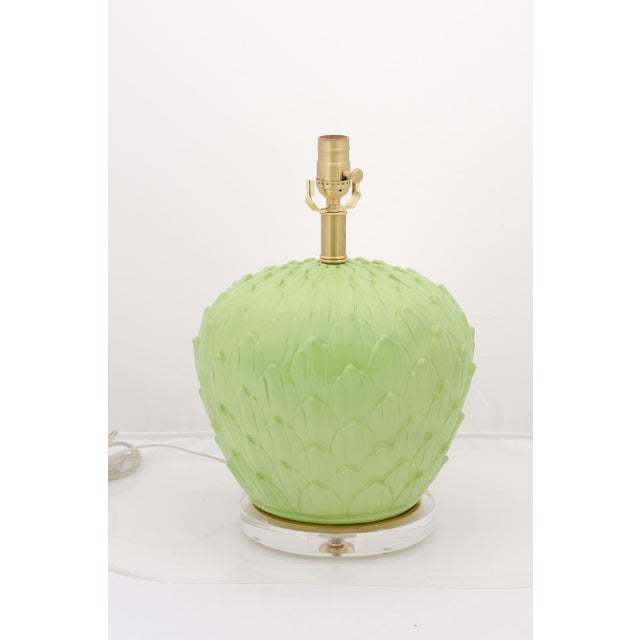 A bold pair of Mid-Century green ceramic artichoke lamps with brushed brass hardware and round lucite bases. The bases are...