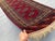 A refined vintage Yomut Turkmen runner showcasing the tribe's prized "Kepse" gul — a single vertical column of lozenge-...