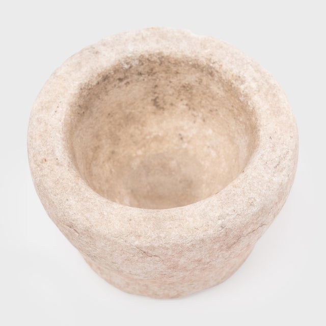 Hand-carved from a single block of marble, this original stone vessel is an antique Chinese mortar once used to grind...