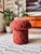A handmade mushroom shaped ottoman, upholstered in a dotted wool blend fabric. "Sedona" fabric is in the rust color family...