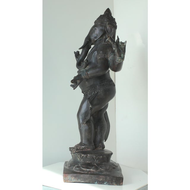Description Large Bronze antique Chola style Ganesha. Ganesha is the elephant headed son of Shiva. He holds his broken...