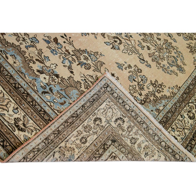 Beautiful Vintage Malayer hand-knotted wool rug with a peach field. This Persian rug has a pink border, blue and brown...