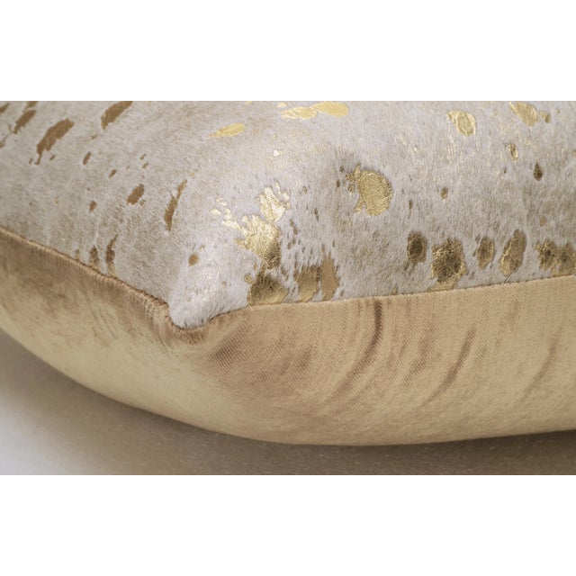 Metalic Brazilian Cowhide, Gold Silky Velvet back, Fiber insert This pillow is made using unique cowhides, with no two...