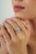 This floral cocktail ring features a 1.25 carat turquoise set in 14k yellow gold. The center stone measuring 7 mm in size,...