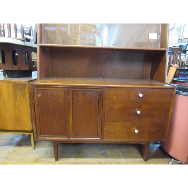 Beautiful Mid-Century Modern wall unit designed by Kipp Stewart. One piece unit with cabinet storage, drawers and sliding...