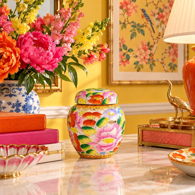 A vintage porcelain ginger jar, hand-painted with colorful flowers and metallic gold accents. Good condition.