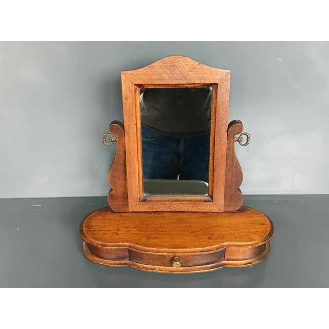 French 19th century mirror in solid wood. Tilt adjustable. Very good condition with traces of wear related to age....