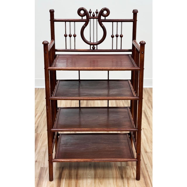 Antique mahogany four tier etagere bookshelf. Victorian era stand features a wood "stick and ball" frame with four...