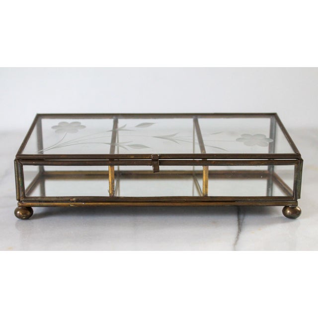 Vintage Brass and glass trinket box with etched glass flowers and mirrored bottom. No makers mark. Minor age wear. No...