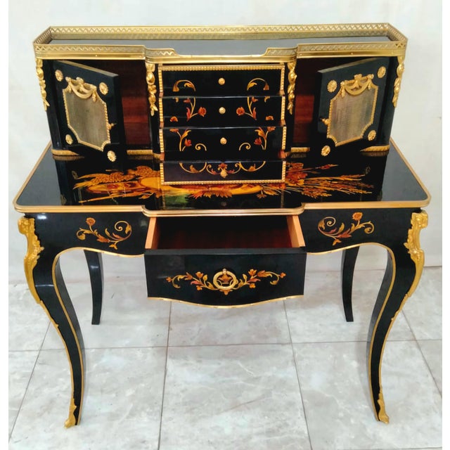 Make a sophisticated statement with this French Louis XV-inspired writing desk, featuring a dramatic black wood finish...