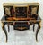 Make a sophisticated statement with this French Louis XV-inspired writing desk, featuring a dramatic black wood finish...